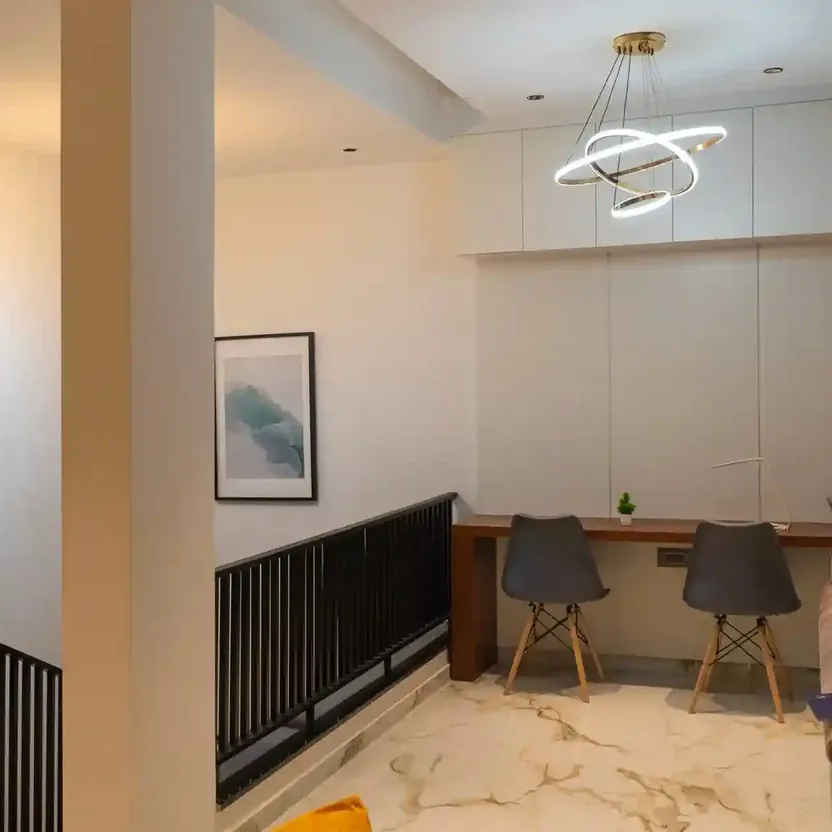 Elegance by Guru Punvaanii, Bidadi, show villa A work corner with a desk and chairs on an upper landing in the Elegance show villa